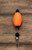 FOUR HORSEMAN Four Horsemen Oval Poppers, colorful fishing lure with orange, black, and silver parts on a wooden surface.
