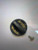 F&F Penn Low Profile Knob for Fathom Reels, black round knob with yellow branding and a screw.