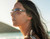 Costa Costa Sunglasses Loreto, stylish woman wearing sunglasses outdoors by the water at sunset.