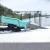 TOADFISH Toadfish Fixed Fillet Knife with Sheath, fishing knife with a turquoise handle and protective sheath, outdoor dock setting with water in the background.