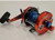 AKIOS Akios S-LINE CTM 656 RGX OTB, fishing reel with red and black body, blue spool, and ergonomic handle for smooth operation.
