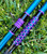 NICK'S CUSTOM RODS 2025 Nick's Custom Rods - CTS 1305, blue and black fishing rod with purple geometric pattern on the handle, lying on green grass.