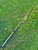 Nick's Custom Rods 2025 Nick's Custom Rods - CTS 1305, a fishing rod on green grass.