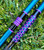 Nick's Custom Rods 2025, CTS 1305 fishing rods with vibrant blue and purple designs, lying on green grass.