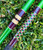 NICK'S CUSTOM RODS 2025 Nick's Custom Rods - CTS 1305, fishing rod with green and intricate geometric design, lying on grass.