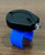 Reel Glo Reel Glo Reel Illuminator, compact device with a black top and a blue curved support, used for highlighting or illuminating objects.
