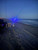 Reel Glo Reel Glo Reel Illuminator, illuminated fishing rod on a beach at dusk.