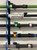 Reel Glo Reel Glo Reel Illuminator, icluding various fishing rods with colorful guides and handles mounted on a wall display