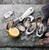 TOADFISH Toadfish White Oyster Knife, stainless steel oyster shucking knife with white handle and oyster shells and lemon slice on a slate surface.