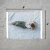 TOADFISH Toadfish Cotton Beach Towel - 6ft, top view of a person lying on a light blue beach towel on gray sand, measuring 6 feet by 4 feet.