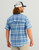 HUK Diamond Back Current Plaid SS, man wearing a blue plaid short-sleeve shirt and a trucker cap.