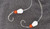 Hook'd On Reelin' Grim Reaper Rigs, fishing hooks with white and orange beads on grey background.