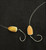 Hook'd On Reelin' Grim Reaper Rigs, fishing lures with hooks, featuring yellow and orange fish-shaped bodies on black background.