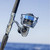 TSUNAMI Tsunami Shield II Spinning Reel, close-up image of a high-quality spinning reel mounted on a fishing rod with blue fishing line, designed for saltwater fishing.
