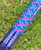 NICK'S CUSTOM RODS 2025 Fall Nick's Custom Rods - CTS 1205 Spinning fishing rod with a colorful geometric pattern in blue, purple, and green on the handle, outdoor background.