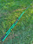 Nick's Custom Rods 2025 Fall - CTS 1205 Spinning fishing rod, turquoise and black, lying on green grass.