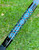 NICK'S CUSTOM RODS 2025 Fall Nick's Custom Rods - CTS 1205 Spinning, close-up of a colorful fishing rod with geometric blue and gold patterns on a black background, outdoor grass setting
