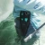 TOADFISH Toadfish Inshore 8" Stainless Pliers - Elite Series, a person wearing waders holding the stainless fishing pliers near water.