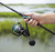 Toadfish Carbon II Spinning Combos, a fishing rod and reel combo held in a person's hand, suitable for freshwater or saltwater fishing.