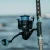TOADFISH Toadfish Surf Combo, close-up of fishing reel and rod with ocean in the background.