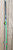 TICA USA, INC Tica Wasabi Surf Stick Spinning Rod, green and black fishing rod with a telescopic design displayed vertically against a wooden background.