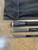 NINJA TACKLE Ninja Tackle Dagger Midnight Bomber LE 13'3" Surf Rod, three-piece surf fishing rod with black and gray handle sections, displayed on a concrete surface with a black carrying bag.
