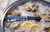 TOADFISH Toadfish Abalone Oyster Shucking Knife, limited edition, blue and abalone shell handle with 'Put 'Em Back' inscription on blade, placed on ice with oysters and lemon slices.
