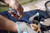 TOADFISH Toadfish Abalone Oyster Shucking Knife, person using the knife to open an abalone shell outdoors.