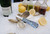 TOADFISH Toadfish Abalone Oyster Shucking Knife, with an iridescent handle, displayed on ice alongside oysters, lemons, and various sauces for seafood preparation.