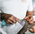 ToADFISH Toadfish Crab Mallet, person holding a crab mallet and cleaning a crab at a seafood market.