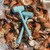 Toadfish Crab Mallet, a light blue rubber mallet with a metal head, resting on a bed of fresh crabs and crushed ice.
