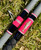 Nick's Custom Rods 2026, CTS 1205 Conventional fishing rod with pink and black accents, featuring a fish graphic on the handle lying on grass.