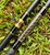 NICK'S CUSTOM RODS 2026 Nick's Custom Rods - CTS 1205 Conventional fishing rod, black with gold decorative patterns, lying on green grass.
