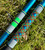 Nick's Custom Rods 2026, CTS 1205 Conventional fishing rod with a vibrant, geometric-patterned handle resting on grass.