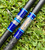 Nick's Custom Rods 2026 CTS 1305 Conventional fishing rod, blue and black with fish graphic and blue plaid design, lying on green grass.