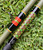 NICK'S CUSTOM RODS 2026 Nick's Custom Rods - CTS 1305 Conventional fishing rod, with detailed colorful wrap and a reel seat, lying on green grass