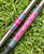 Nick's Custom Rods 2026, CTS 1305 Conventional fishing rod with pink geometric pattern on the handle, lying on green grass.