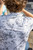 HUK Pursuit KC Printed Polo, close-up of the back of a person wearing a white and gray patterned polo shirt with the HUK logo on the back