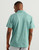 HUK Pursuit Polo, front view of a man wearing a light teal polo shirt with a small HUK logo on the back of the collar, against a plain light background.