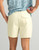 HUK Shoreside Short Solid, light yellow men's casual shorts with back pocket, shown on a person.