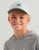 HUK Kids Lab Patch Trucker cap, a white and light blue children's trucker hat with a patch displaying a black dog and the brand logo.