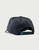 HUK Born Wave Performance Hat, rear view showing navy blue color with perforated design and adjustable snapback strap.