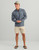 HUK Huk Airweight Heather 1/4 Zip, a men's lightweight performance pullover in heather gray with a quarter-zip neckline and the HUK logo on the chest.