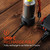 Nebo Tempest 500 Rechargeable Lantern, image showing a portable LED lantern plugged into a power source with a USB-C charging cable, on a wooden surface.