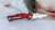 BUBBA BLADE Bubba Sculpin Snip, compact fishing knife with a red handle and a sharp, serrated blade for fish preparation.