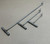 DEERFIELD FABRICATION Deerfield Fabrication De-Hooker S-Bend, set of metal rods with hooked ends and cylindrical connectors on a beige background.