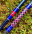 NICK'S CUSTOM RODS 2026 Nick's Custom Rods CTS 1303, fishing rods with vibrant blue and red geometric patterns lying on grass.