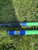 Full Send Rod Co. Custom CTS 1205 fishing rods, close-up of two green rods lying on grass with blue accents.