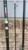 AKIOS Akios Fury FX400 Rod, fishing rod with black, green, and silver accents leaning against a brick wall.