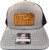 F&F Richardson 112+ Reflex Leather Sign Patch, close-up of a gray trucker cap with orange leather-style patch featuring the text 'Frank & Fran's Bait & Tackle' and a fish logo.